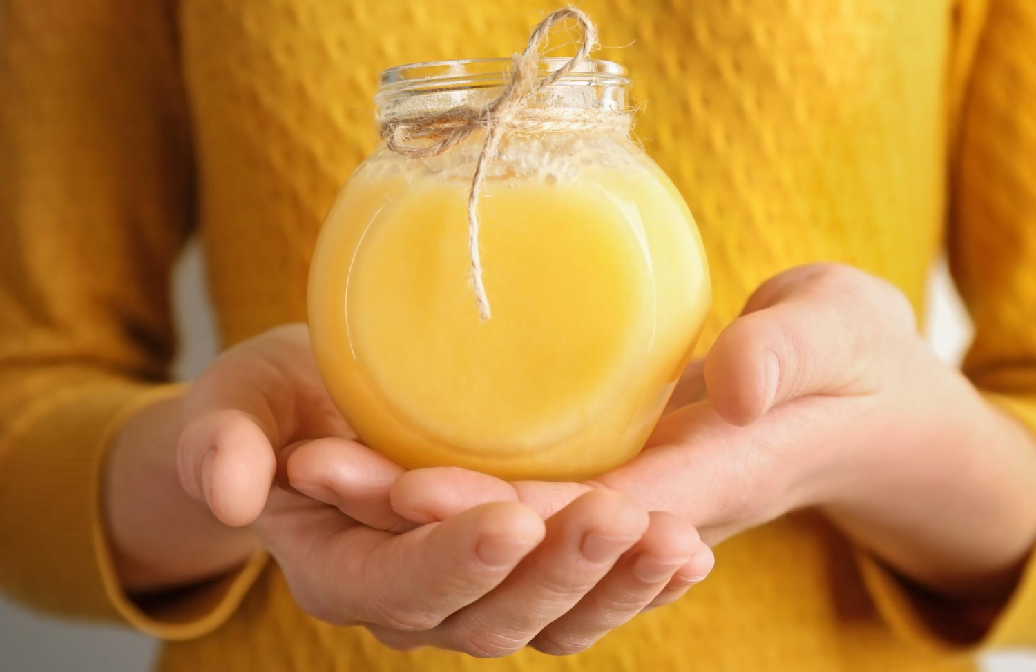 Jar of premium ghee on a kitchen surface